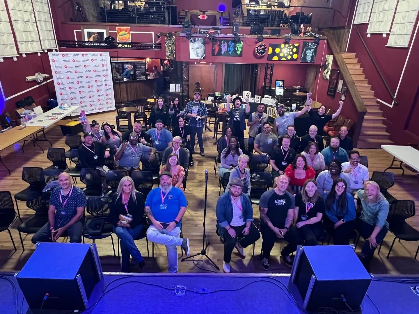 The ARKAST crowd gathered for a group photo in front of the ARKAST banner
