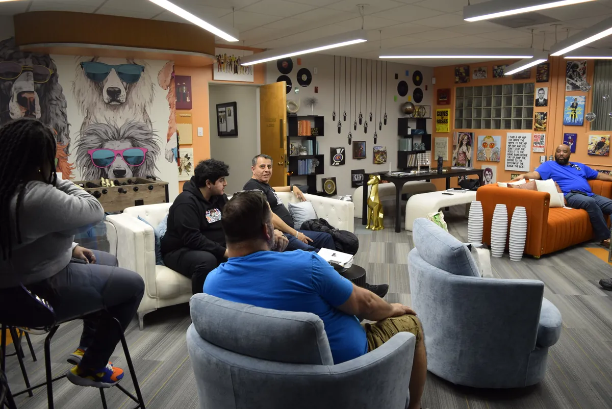 Members talking on the couches at a monthly meetup