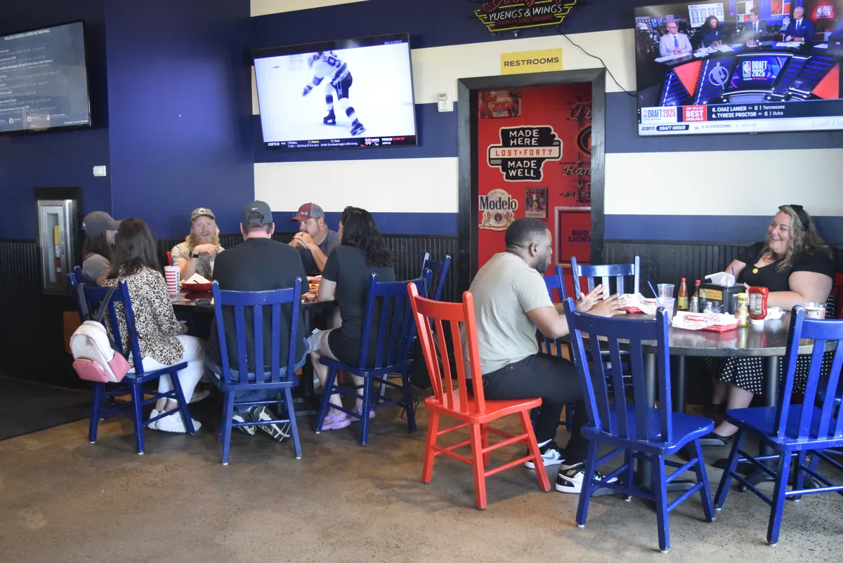 Podcasters around a table at a monthly meetup