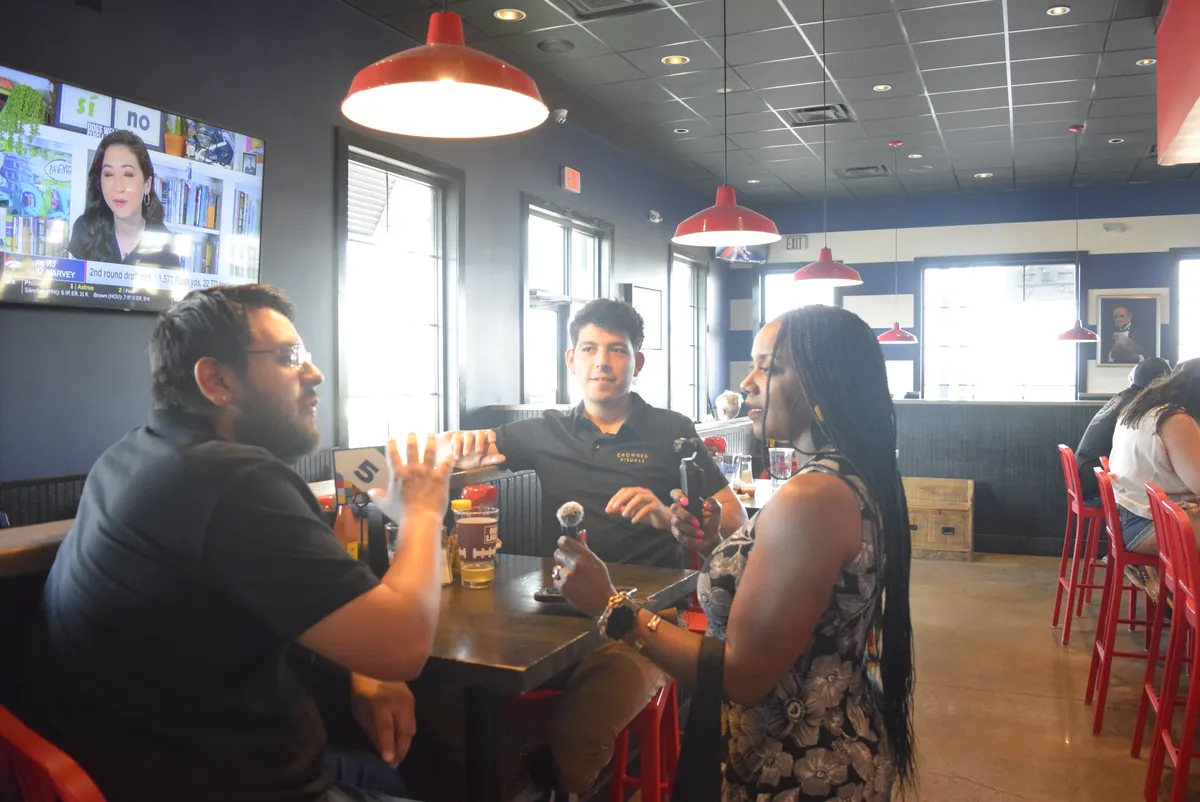 Members working with recording gear at a monthly meetup